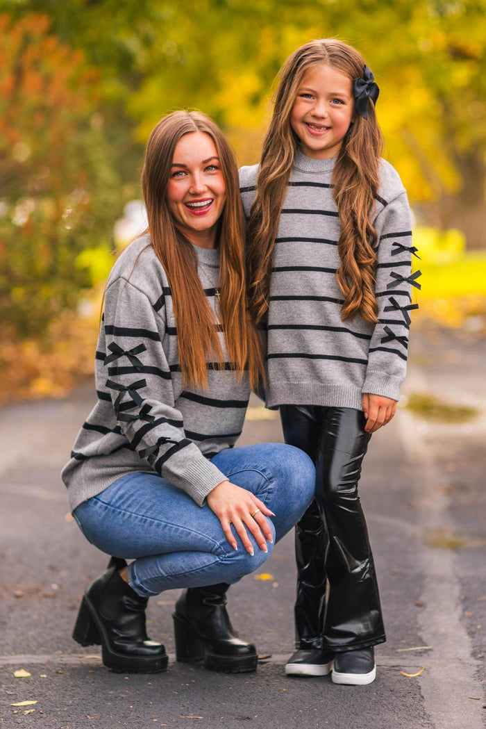 Mom & Me - Gray Striped Sweater & Pant Set - CHILD-3XS-6-12 Months - Gray sweater and pants set with black horizontal stripes and graphic text on sleeves, worn by woman and girl outdoors.