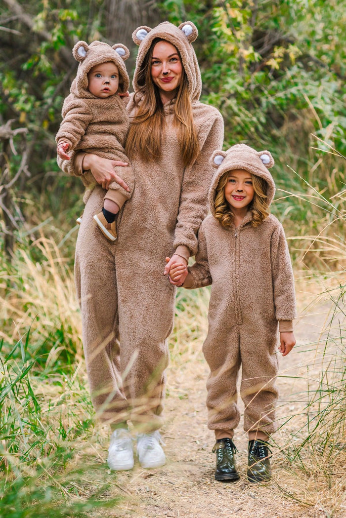 Mom & Me - Bear Onesies - CHILD-3XS-6-12 Months - Brown fuzzy bear onesies with ears on hood worn by mother and two children outdoors.