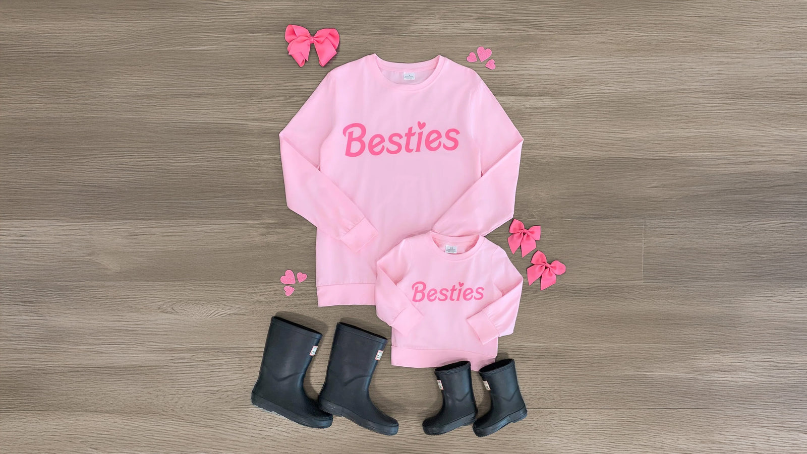 Two pink long sleeve tops with a playful 'Besties' design embossed on the front, displayed to highlight their soft and breathable fabric. Perfect for little ones and their moms to match, these versatile tops pair beautifully with Sparkle in Pink (SIP) bottoms and booties, making them ideal for any adventure