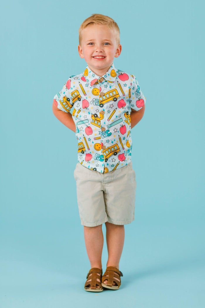 Pastel School Button Down Top - Small-3T - Toddler boy wearing pastel blue button-down shirt with colorful school-themed prints and khaki shorts.
