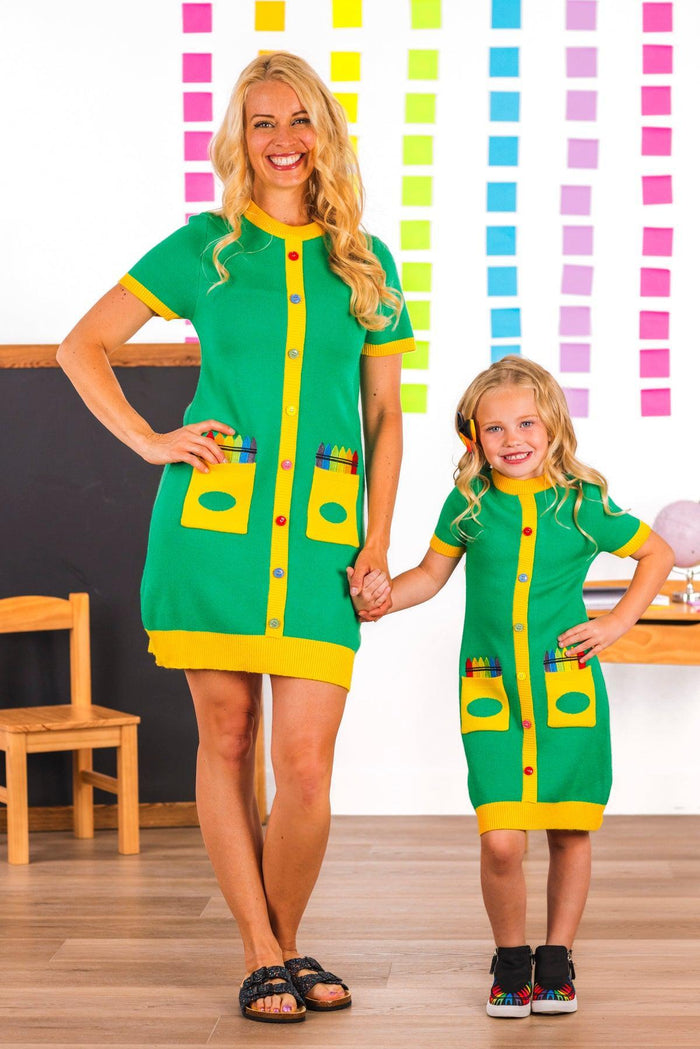 Mom & Me - Crayon Box Sweater Dress - CHILD-3T - Green sweater dresses with yellow button placket and crayon box pocket design worn by woman and girl.