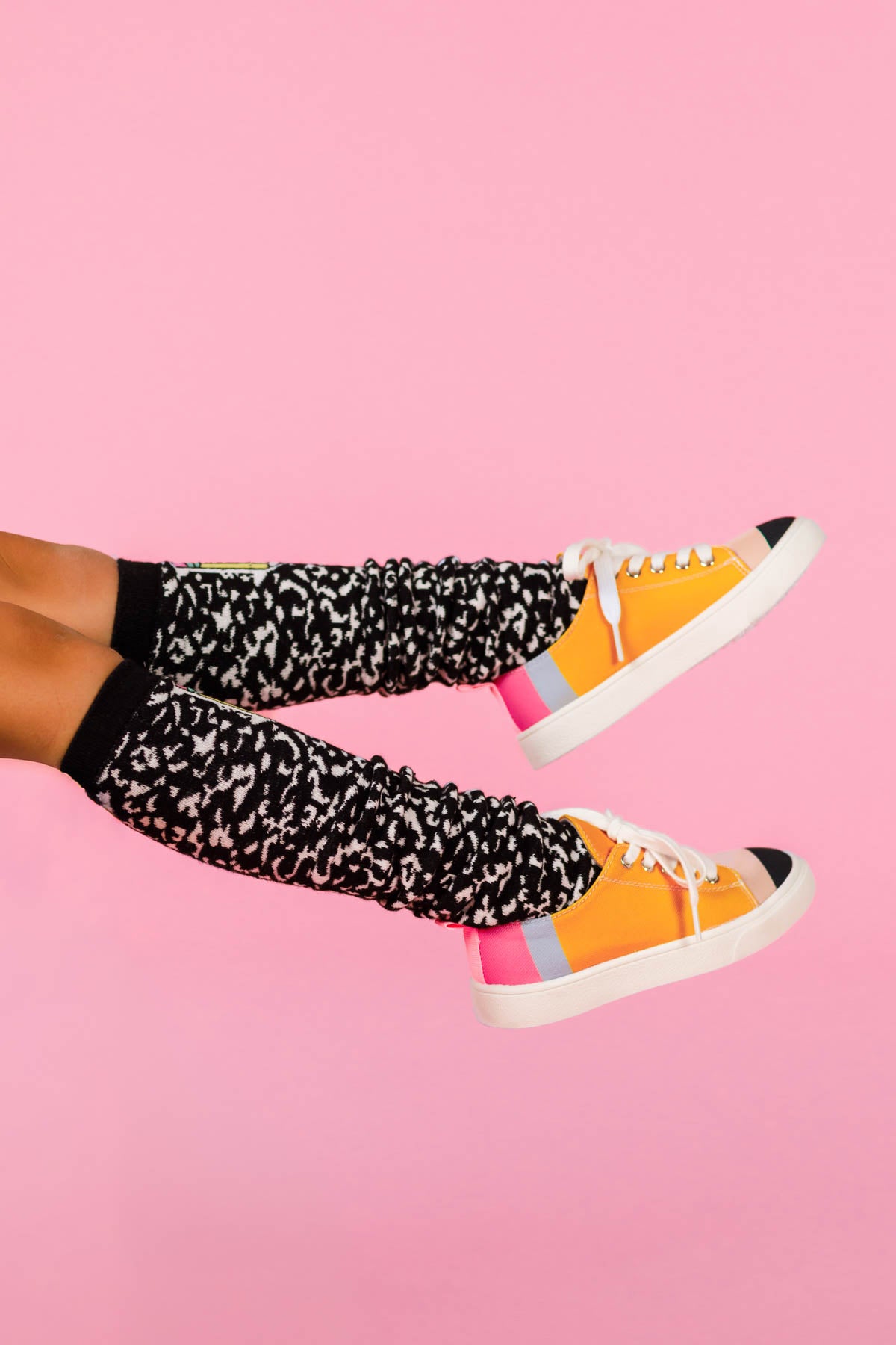 Composition Notebook Knee High Socks - Default Title - Black knee-high socks with white composition notebook-style print on legs against a pink background.