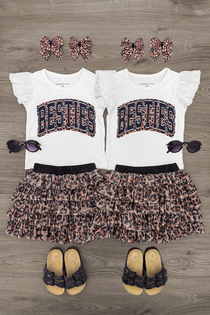 "Besties" Cheetah Sequin Skirt Set - 6-12 Months - Matching white flutter sleeve tops with "BESTIES" in navy and orange sequins paired with cheetah print ruffled sequin skirts .