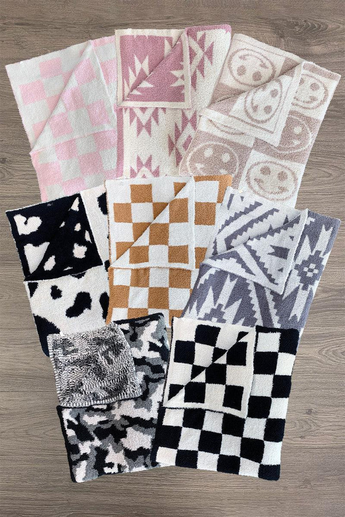 Cozy Throw Blankets - Baby / Pink Checkered - Nine cozy throw blankets in various patterns including pink checkered, mauve southwestern, smiley faces, black checkered,.