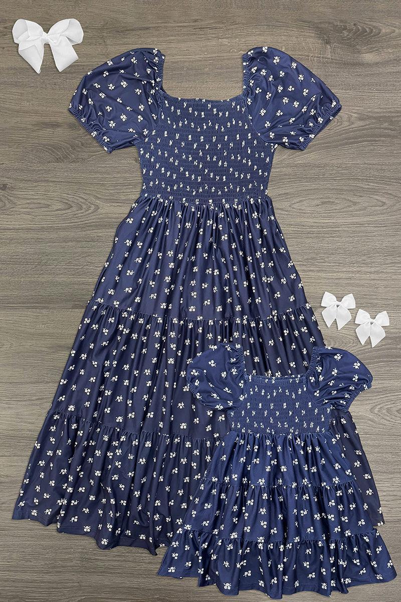 Mom & Me - Navy Floral Dress - CHILD-6-12 Months - Matching navy floral dresses with puff sleeves, a smocked bodice, and flowing gathered skirts in two sizes.