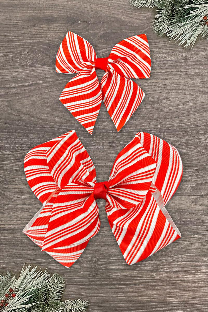 Candy Cane Stripe Bows - 3 inches - Two red and white striped candy cane bows in 3-inch and 6-inch sizes on wooden background with pine branches.