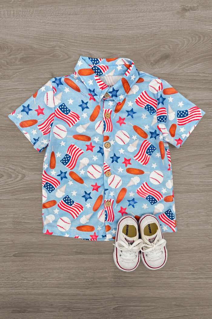 American Summer Baseball Button Down - 6-12 Months - Blue short-sleeve baseball button-down shirt with red, white, and blue sports-themed prints and white toddler shoes.