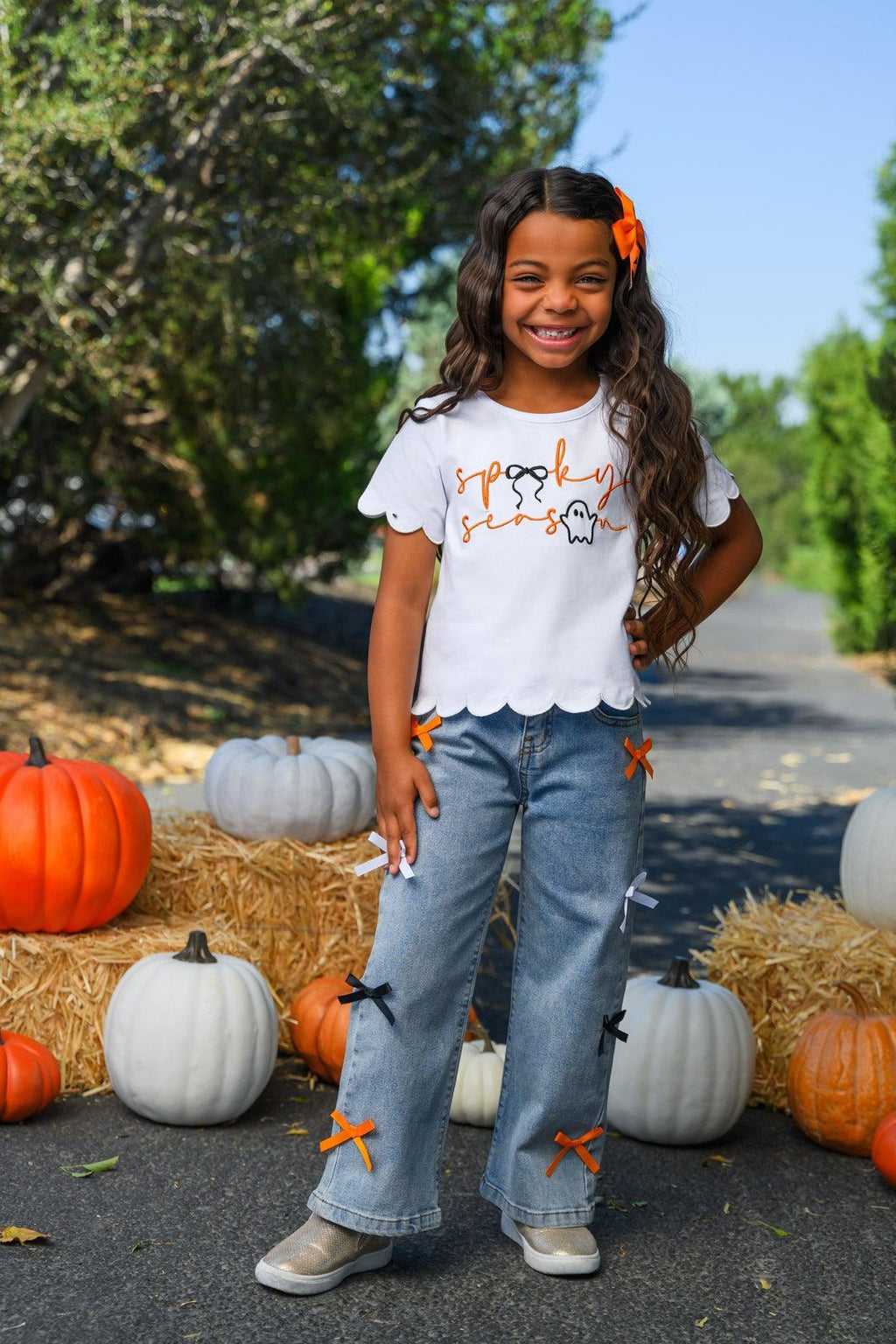 "Spooky Season" Bow Denim Pant Set - 6-12 Months - White short-sleeve ruffle-hem top with Halloween print and light blue denim pants featuring orange bows on the legs.