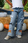 "Spooky Season" Bow Denim Pant Set - 6-12 Months - Light blue denim pants with wide legs featuring black, white, and orange bow accents on front thighs and lower legs.