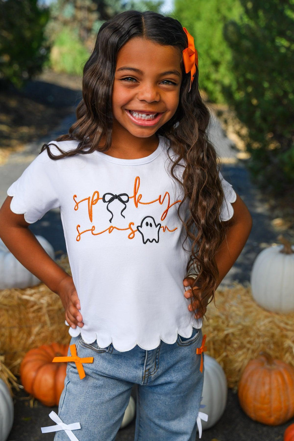 "Spooky Season" Bow Denim Pant Set - 6-12 Months - White short-sleeve shirt with scalloped edges and orange "spooky season" text paired with light blue denim pants and an.