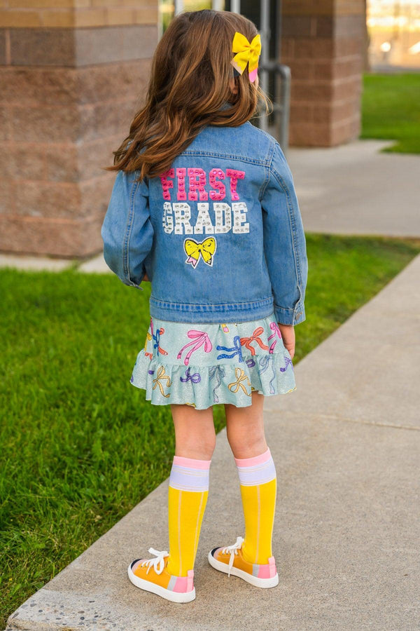 "Preschool - Sixth Grade" Denim Jacket - PRESCHOOL / 3T - Light blue denim jacket with pink and white "First Grade" text and yellow butterfly on the back.