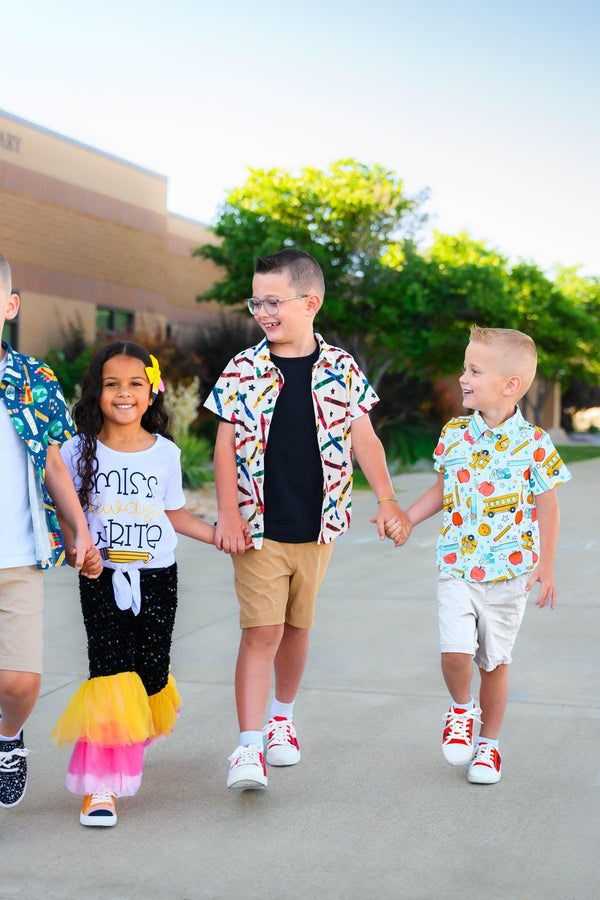 Crayons & Stars Button Down Top - 3T - Cream button-down top with colorful crayon and star print worn by child walking with two others outdoors.