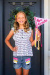 "Pre-K - Sixth Grade" Notebook Denim Short Set - PRE-K / 2T - Girl wearing white sleeveless top with navy handwritten script and denim shorts with colorful patch pockets holding 6th.