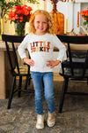 Mom & Kid - "Thankful For My Turkeys & Little Turkey" Top - GIRL-6-12 Months-FAMILY - Smiling girl wearing a white long-sleeve “Little Turkey” shirt with red and black lettering, blue jeans, and white sneakers.