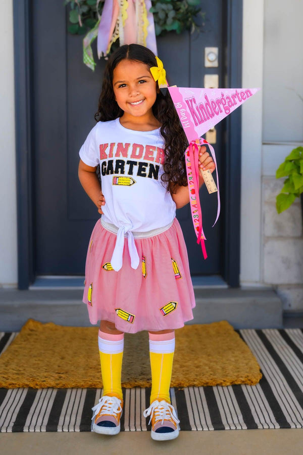 "Pre-K - 6th Grade" Pink Pencil Tutu Skirt Set - PRE-K / 2T - Girl wearing pink pencil tutu skirt decorated with yellow pencils, paired with white Kindergarten t-shirt, yellow leggings,.