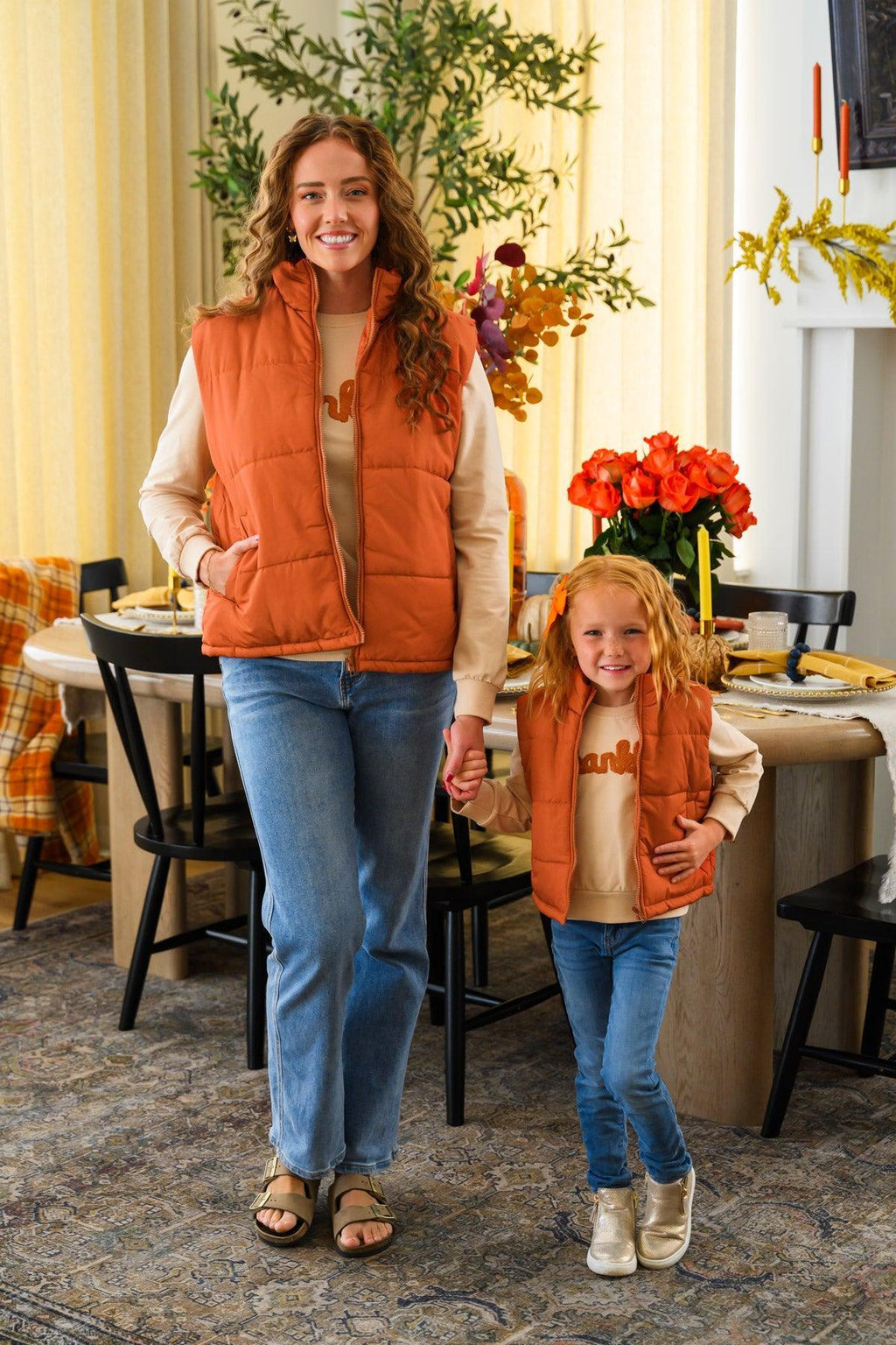 Mom & Me - "Thankful" Vest Set - CHILD-6-12 Months - Mother and child wearing matching rust-orange quilted vests over cream tops and blue jeans.