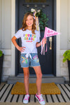 "Pre School - Sixth Grade" Crayon Denim Short Set - PRE-K / 2T - Girl wearing white Fourth Grade tie-front t-shirt with colorful letters and denim shorts decorated with pastel crayon.