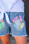 "Pre School - Sixth Grade" Crayon Denim Short Set - PRE-K / 2T - Light blue denim shorts with pastel crayon patches and a frayed hem, paired with a white tied shirt.
