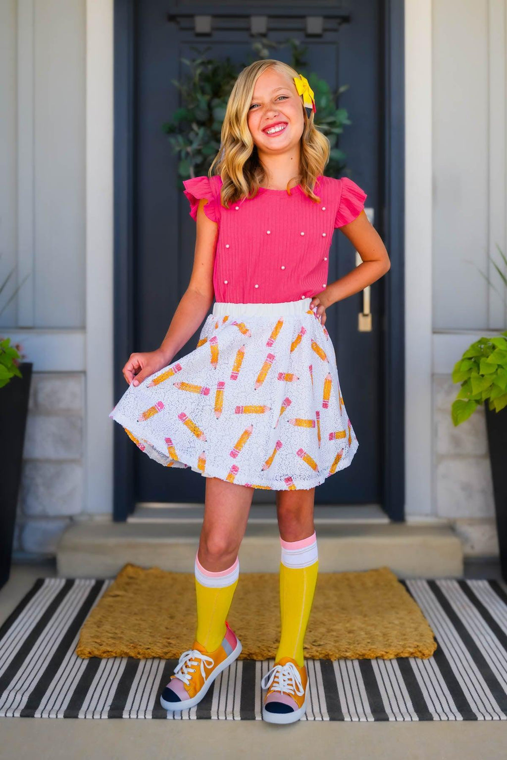 Pink Sequin Pencil Skirt Set - 2T - Girl wearing bright pink short-sleeve top with small embellishments and white skirt with colorful pencil print, paired with.