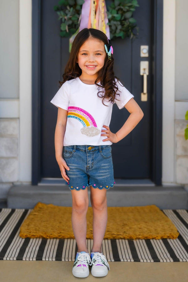Gemstone Rainbow Denim Short Set - Left Side / 6-12 Months - White short-sleeve top with rainbow graphic paired with blue denim shorts featuring rainbow gem accents and scalloped hem.