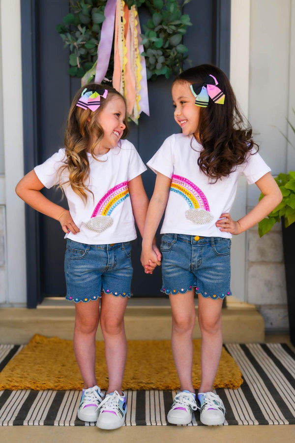 Gemstone Rainbow Denim Short Set - Left Side / 6-12 Months - Girls wearing white t-shirts with rainbow gems and blue denim shorts with scalloped hems and white sneakers.