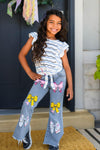 Notebook Bow Flare Denim Pant Set - 3T - Girl wearing light blue flare denim pants with colorful butterfly patches and a white ruffled sleeve striped top.