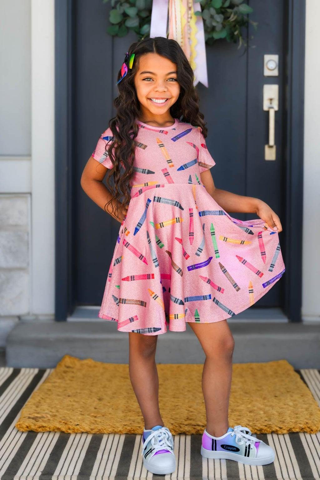Mom & Me - Pink Glitter Crayon Dress - CHILD-2T - Pink short-sleeve dress with glitter crayon print and flared skirt on a smiling girl.