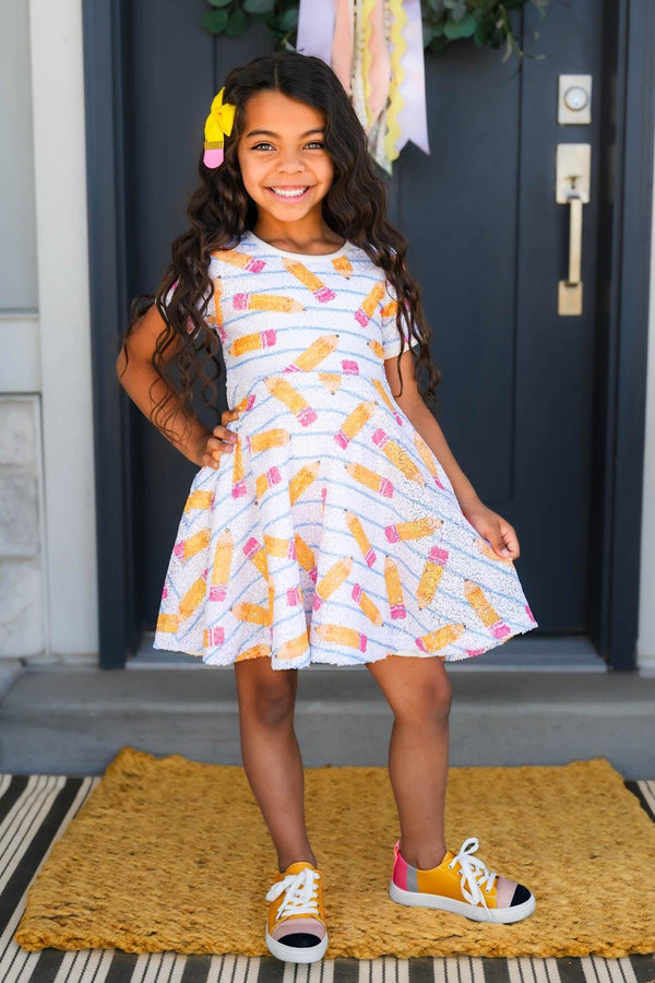Mom & Me - Sequin Pencil Dress - CHILD-2T - White short-sleeve flared dress with colorful sequin pencil designs worn by a smiling girl.