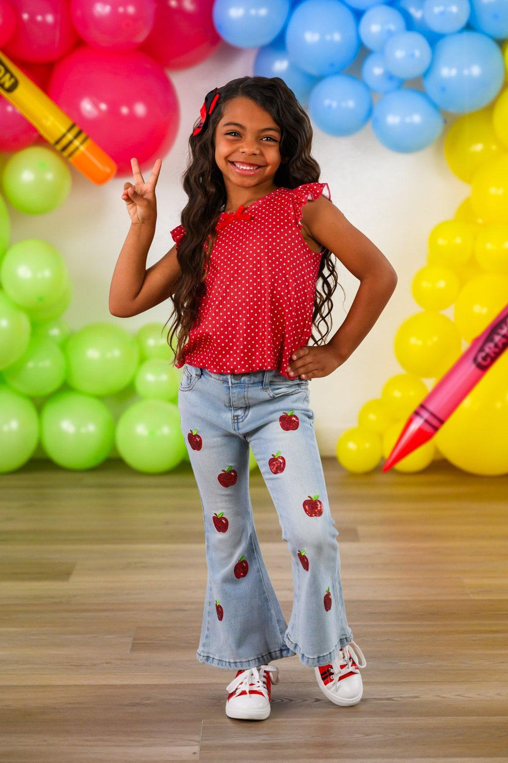 Red Apple Flare Denim Pant Set - 3T - Child wearing light blue flare denim pants decorated with red apple patches paired with a sleeveless red polka-dot top and.