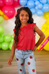 Red Apple Flare Denim Pant Set - 3T - Girl wearing light blue denim flare pants with red apple patches and a sleeveless red polka dot top with ruffled shoulders.