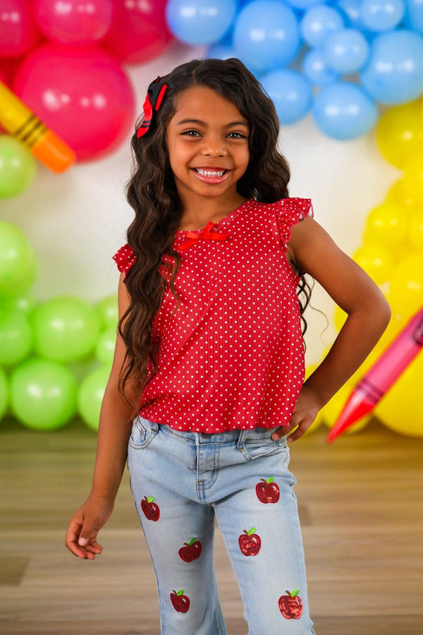 Red Apple Flare Denim Pant Set - 3T - Girl wearing light blue denim flare pants with red apple patches and a sleeveless red polka dot top with ruffled shoulders.