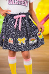 "Pre-K - Sixth Grade" Notebook Skirt Set - PRE-K / 2T - Black gathered skirt with colorful patches and a pink drawstring waistband worn with knee-high white socks with pink stripes.