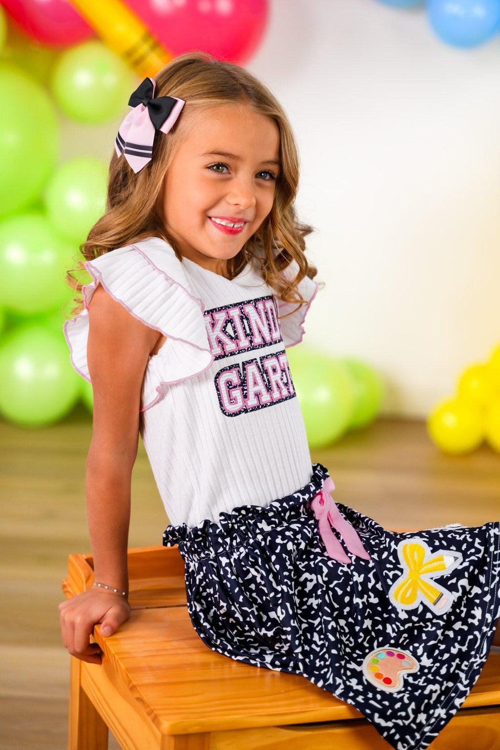 "Pre-K - Sixth Grade" Notebook Skirt Set - PRE-K / 2T - White short-sleeve top with ruffled sleeves and "Pre-Kindergarten" text paired with black skirt patterned like notebook.