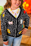 Mom & Me - Composition Sweater Cardigan - CHILD-3T - Black knitted cardigan with white speckled pattern, colorful patch designs, and ribbed cuffs and hem.