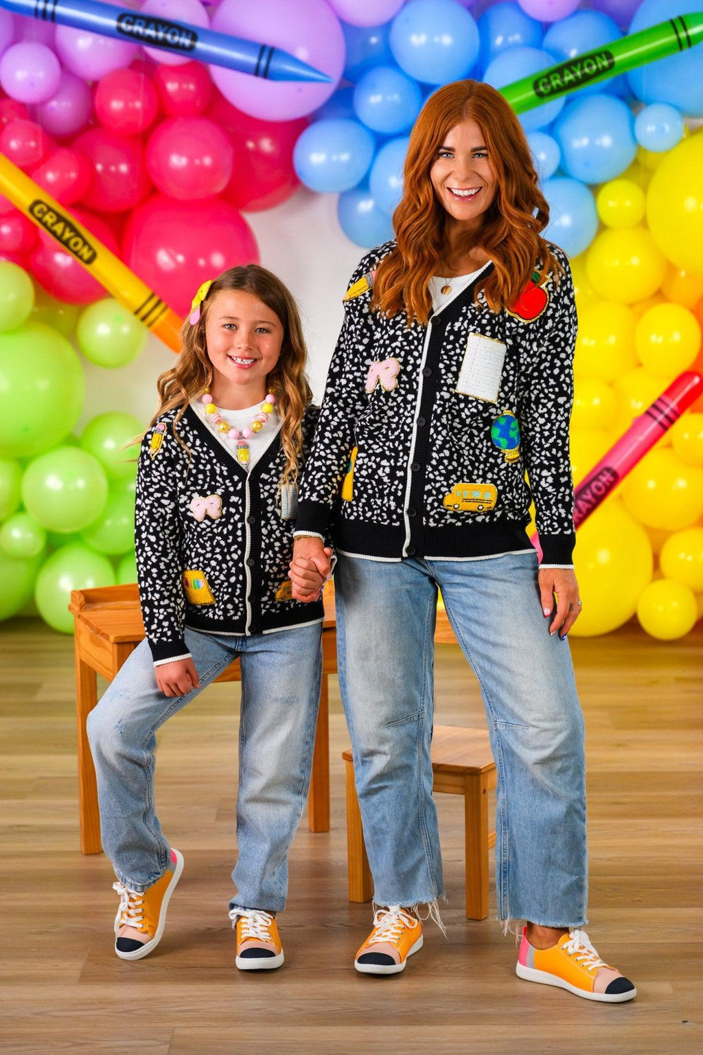 Mom & Me - Composition Sweater Cardigan - CHILD-3T - Black sweater cardigans with white polka dots and colorful patch designs, worn by woman and girl, paired with jeans and.