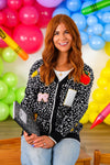 Mom & Me - Composition Sweater Cardigan - CHILD-3T - Black patterned sweater cardigan with colorful patch designs, worn over white top.