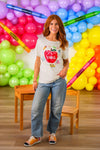 "Teach" Apple Top - MOM-XS - Cream short-sleeve cotton top with red apple graphic and "Teach" text, paired with blue jeans.