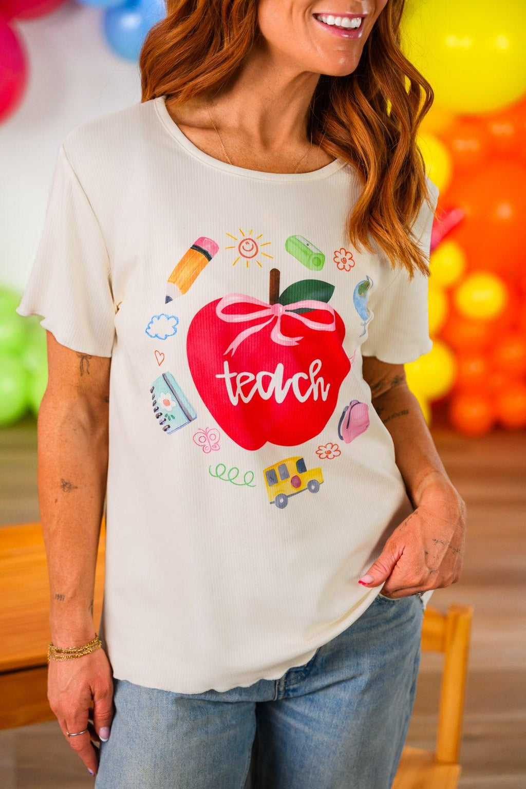 "Teach" Apple Top - MOM-XS - Cream short-sleeve cotton top with a large red apple graphic and the word "teach" in white script surrounded by colorful.