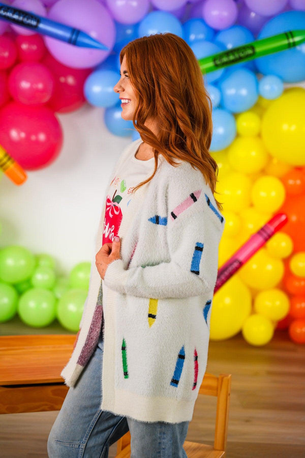 "Teach" Apple Top - MOM-XS - Cream-colored cardigan with colorful crayon-shaped embroidery, worn over a light top.