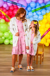 Mom & Me - Pink Pencil & Bow Dress - CHILD-3T - Pink knee-length pencil dresses with short sleeves and bow patterns, worn by woman and girl, styled with white cardigans and