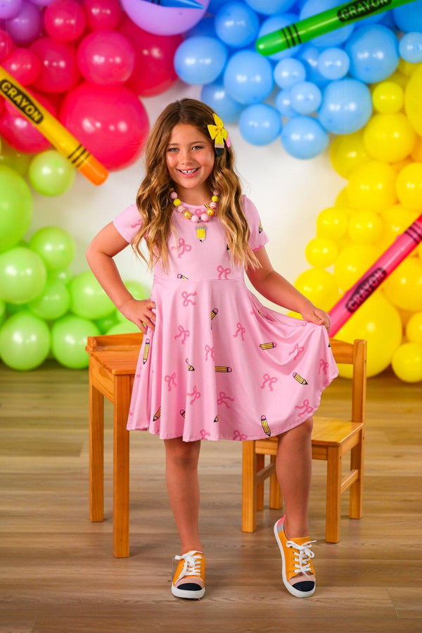 Mom & Me - Pink Pencil & Bow Dress - CHILD-3T - Pink short-sleeve dress with a flared skirt and bow detail, worn by smiling girl with wavy hair.