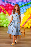 Mom & Me - Blue Pencil Dress - CHILD-3T - Light blue midi pencil dress with short sleeves and scattered tropical fruit print, worn with orange sneakers.