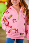 Mom & Me - Pink Pencils & Bows Pullover - 3T - Pink pullover with half-zip, featuring pencil and bow prints, worn by a child with hands in front pocket.