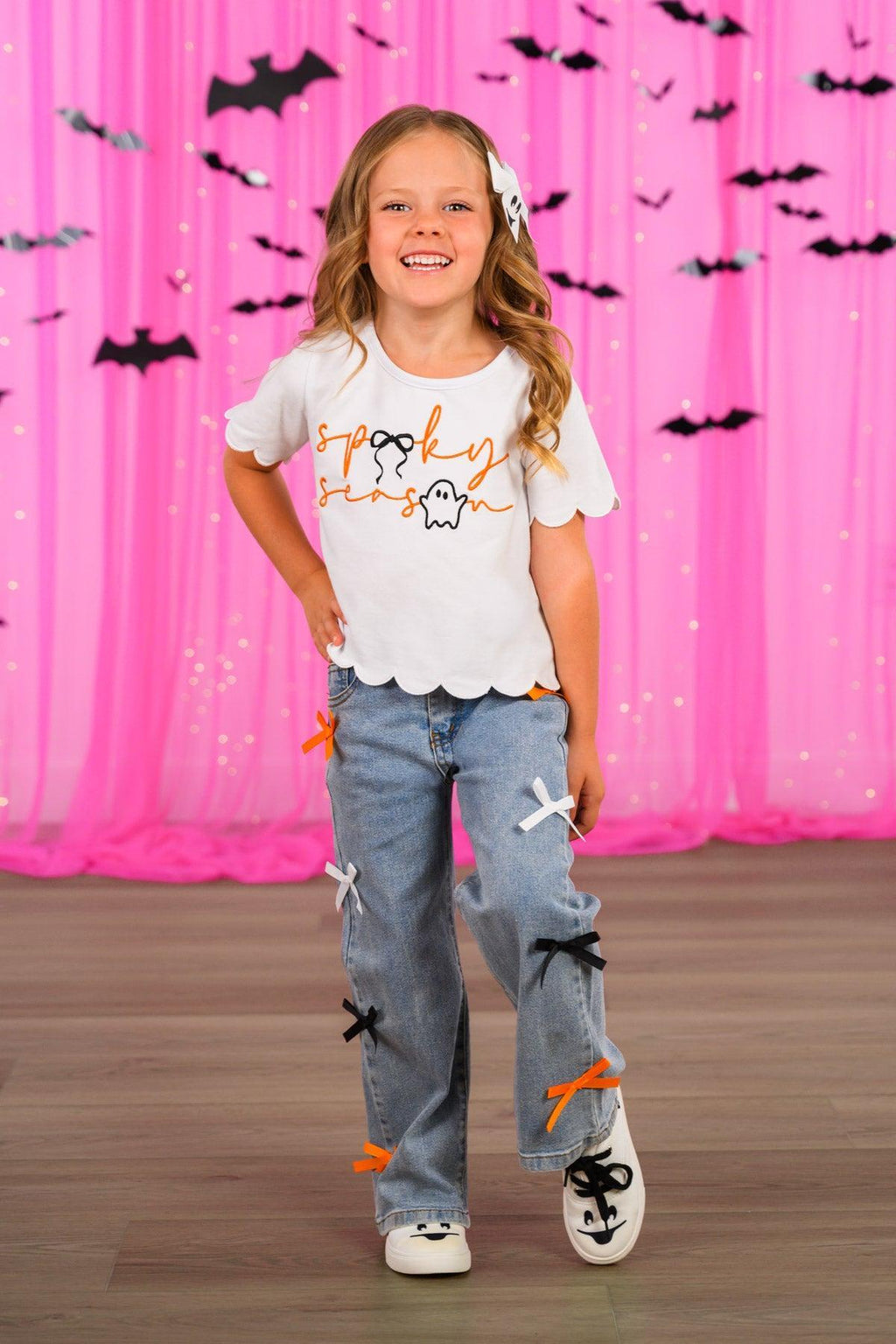 "Spooky Season" Bow Denim Pant Set - 6-12 Months - White short-sleeve top with black and orange Halloween bats print, paired with light blue denim pants featuring large black.
