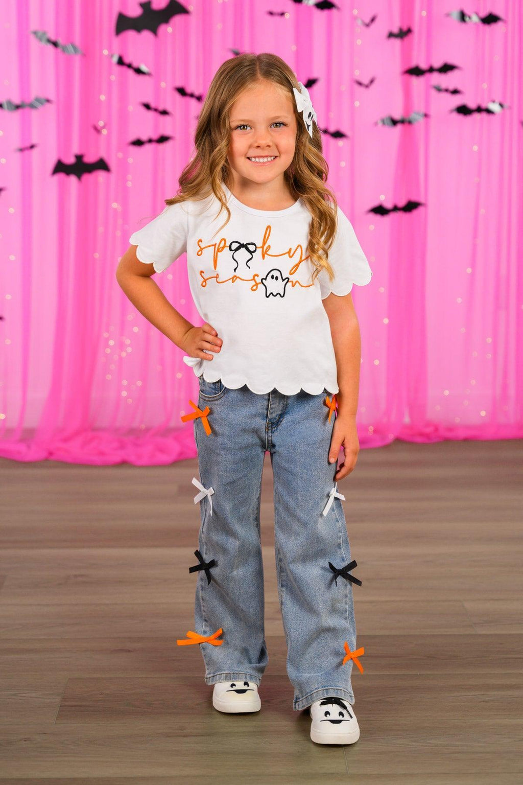 "Spooky Season" Bow Denim Pant Set - 6-12 Months - White short-sleeve top with scalloped hem and "Spooky" text paired with light blue denim pants featuring orange and black.