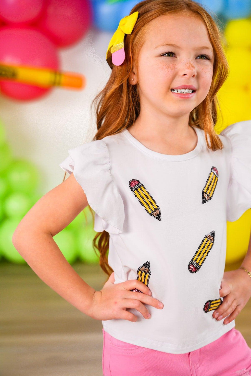 Pink Pencil Flare Denim Pant Set - 3T - White short-sleeve top with ruffled sleeves and yellow pencil graphic prints paired with pink flare denim pants.