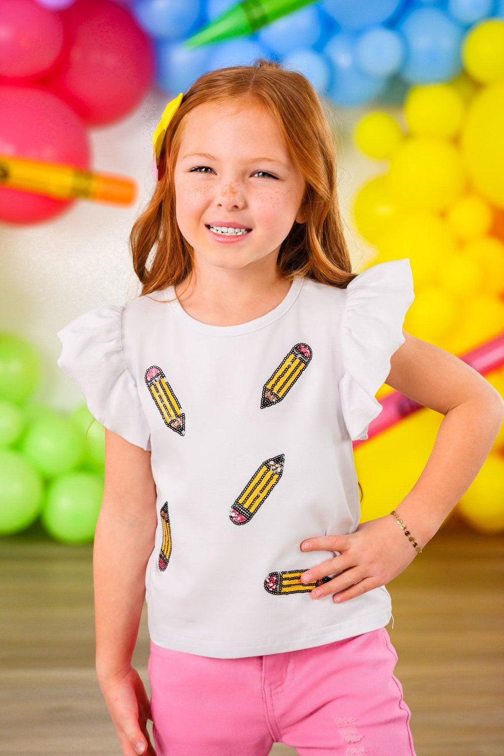 Pink Pencil Flare Denim Pant Set - 3T - White short-sleeve top with ruffled shoulders and colorful pencil prints paired with bright pink flare denim pants.