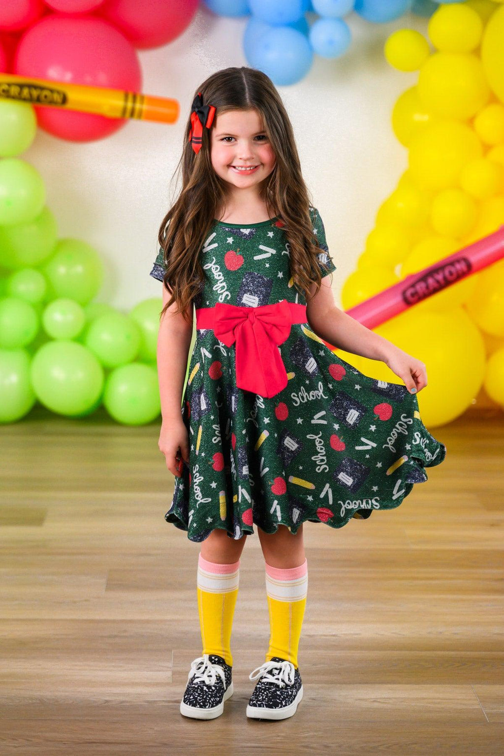 Green Glitter School Supplies Dress - 3T - Green short-sleeve dress with glittery school supply prints and a large pink bow at the waist.