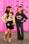 "Wicked Cute" Denim Flare Set - 6-12 Months - Girls wearing Halloween-themed outfits; one in cream sweater with pumpkin and ghost patches and black skirt, the other in.