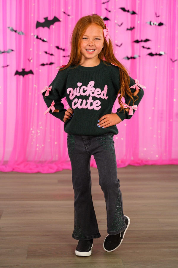 "Wicked Cute" Denim Flare Set - 6-12 Months - Girl wearing black denim flare pants and black long-sleeve top with "wicked cute" pink and white lettering and bat details.